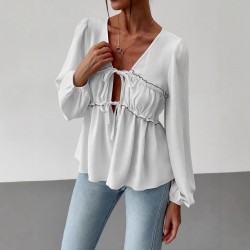 Elegant long-sleeved top, blouse. Loose-fitting V-neck, ruffled hem, contrasting lace-up design for a slimming, versatile shirt.