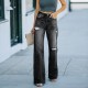 Factory direct sales of fashionable, washed jeans for women, in stock, for foreign trade wholesale. Ripped slim-fitting wide-leg denim trousers Factory direct sales of fashionable, washed jeans for women, in stock, for foreign trade wholesale. Ripped slim-fitting wide-leg denim trousers